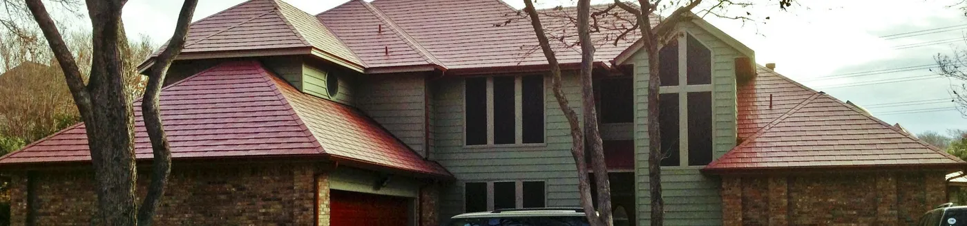 A contemporary two-story with a red metal shingle roof