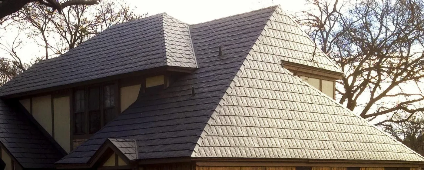 A hip roof of grey stone-coated steel shingle panels