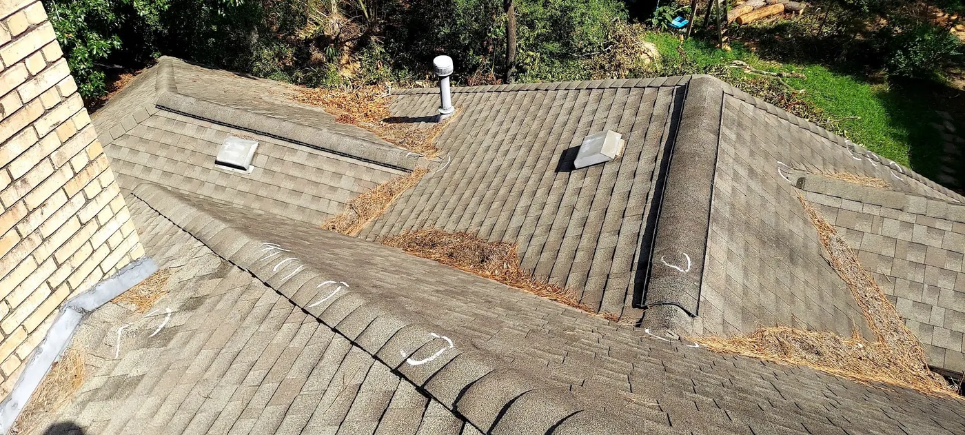 A weathered roof with chalk marks from an inspection